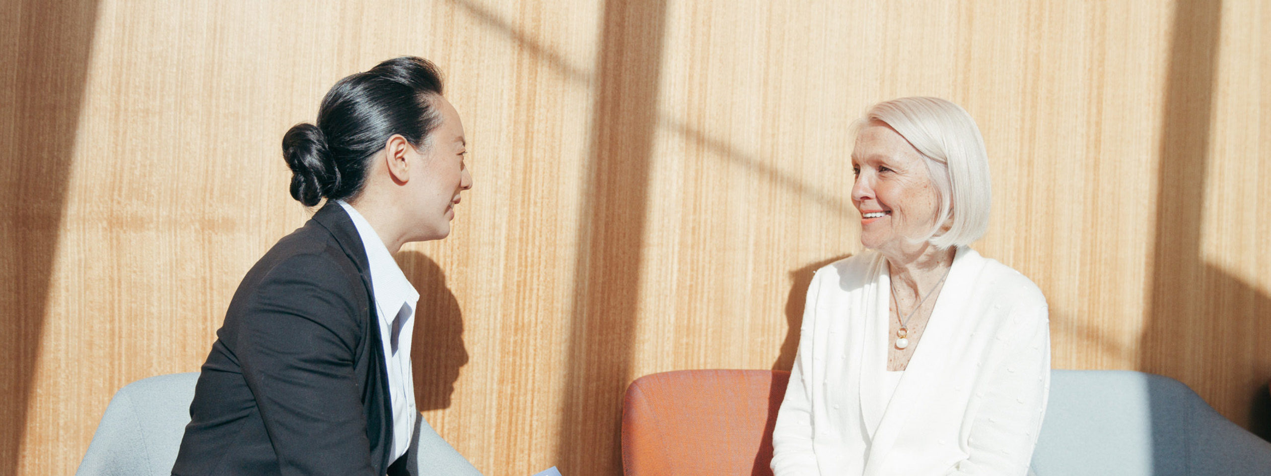 Female staff member talking to older female patient about patient privacy